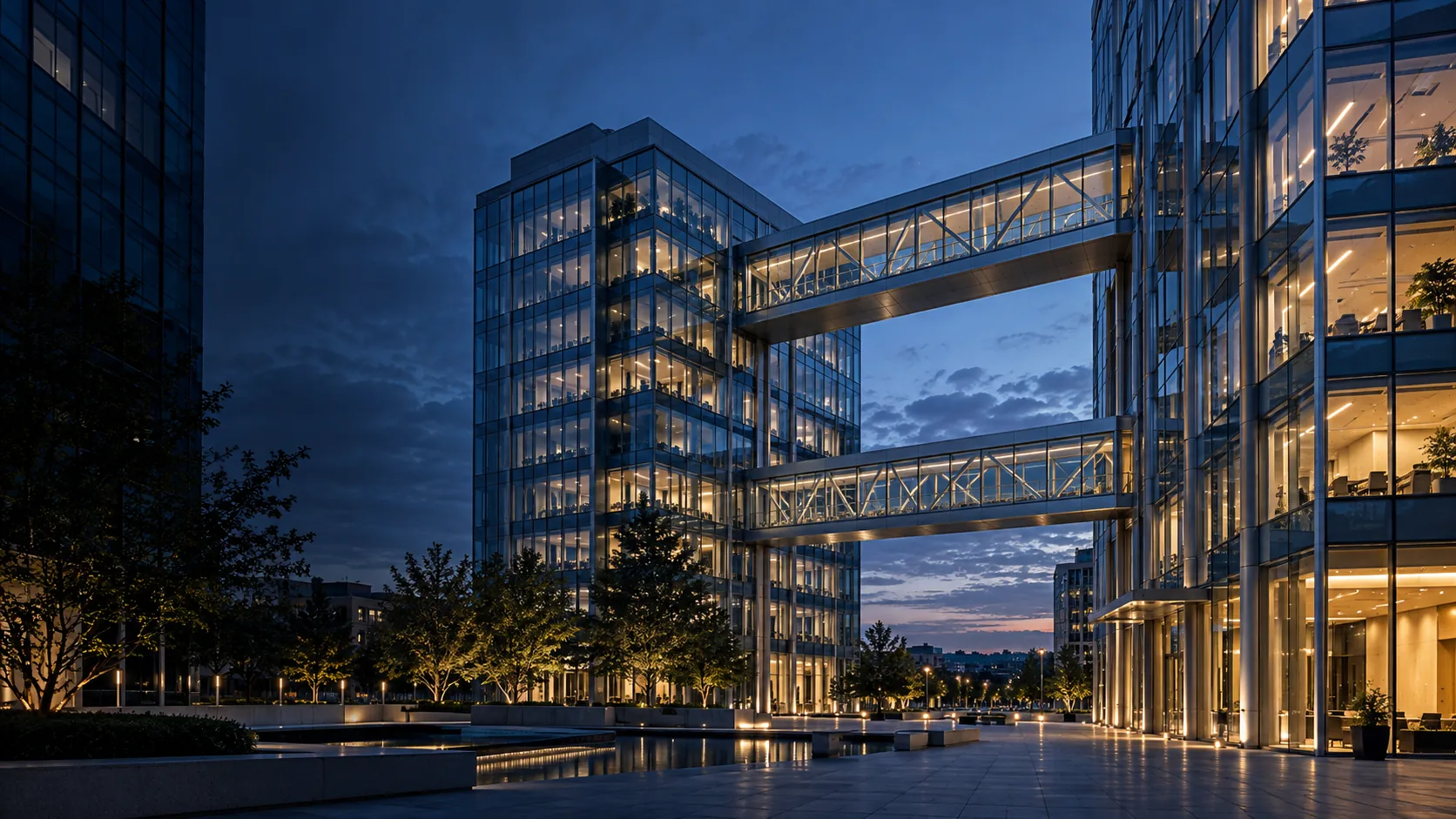 Illustrative office buildings connected by illuminated pedestrian bridges at blue hour